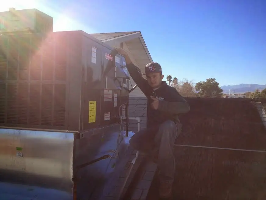 HVAC technician performing HVAC Inspection on a rooftop unit in New Milford